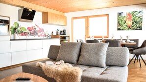 Una sala de estar moderna con un sofá gris, una mesa de centro de madera y una manta de piel.