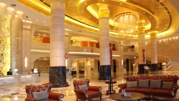 A luxurious lobby with marble columns, ornate chandeliers, and plush seating areas. - Grand Metropark Guofeng Hotel Tangshan (Tangshan)