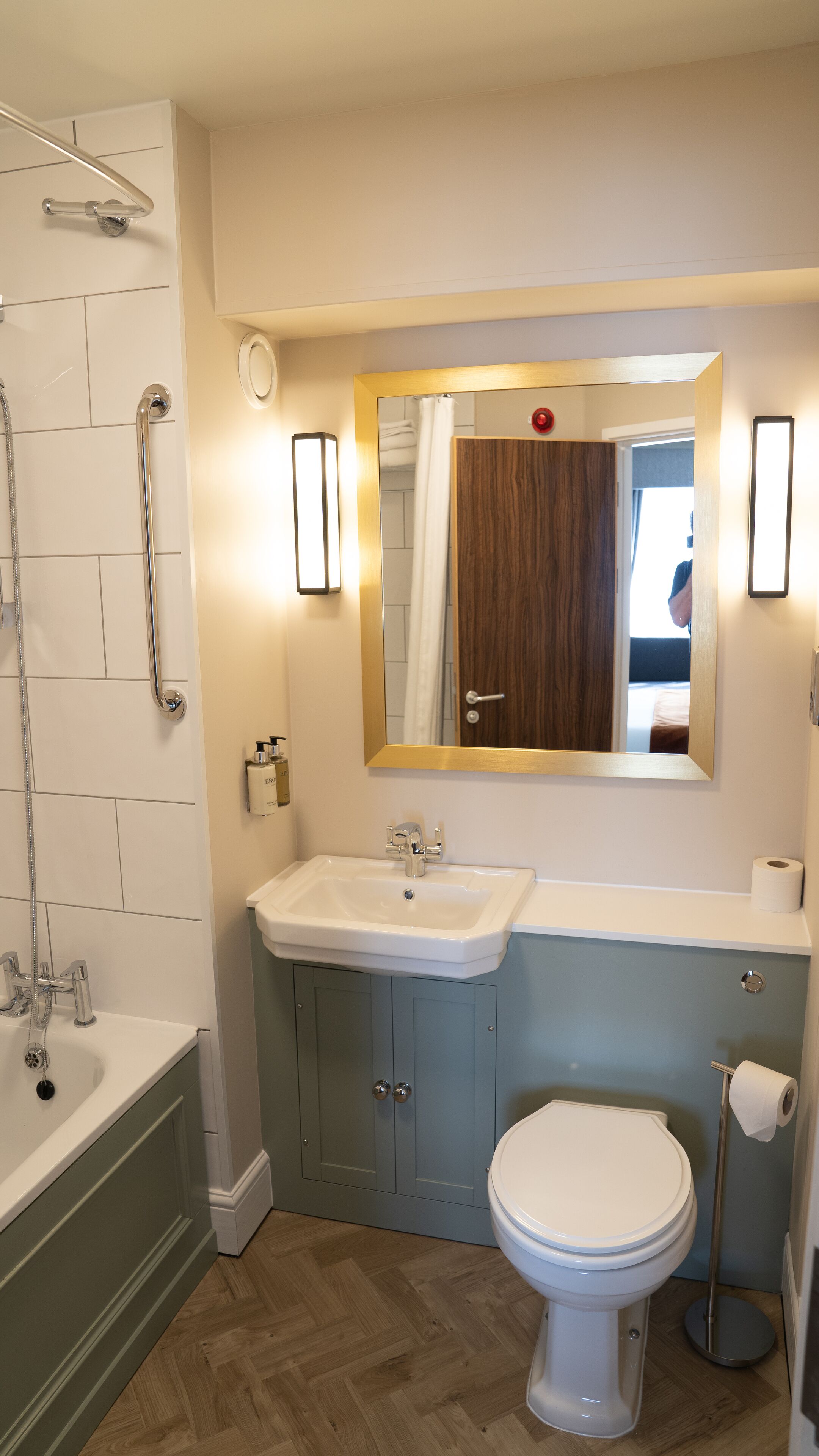 A bathroom with a bathtub, sink, and toilet.