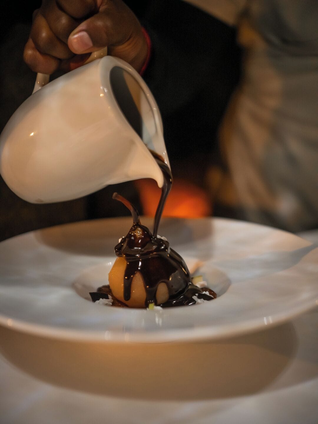 A dessert being poured onto a plate.