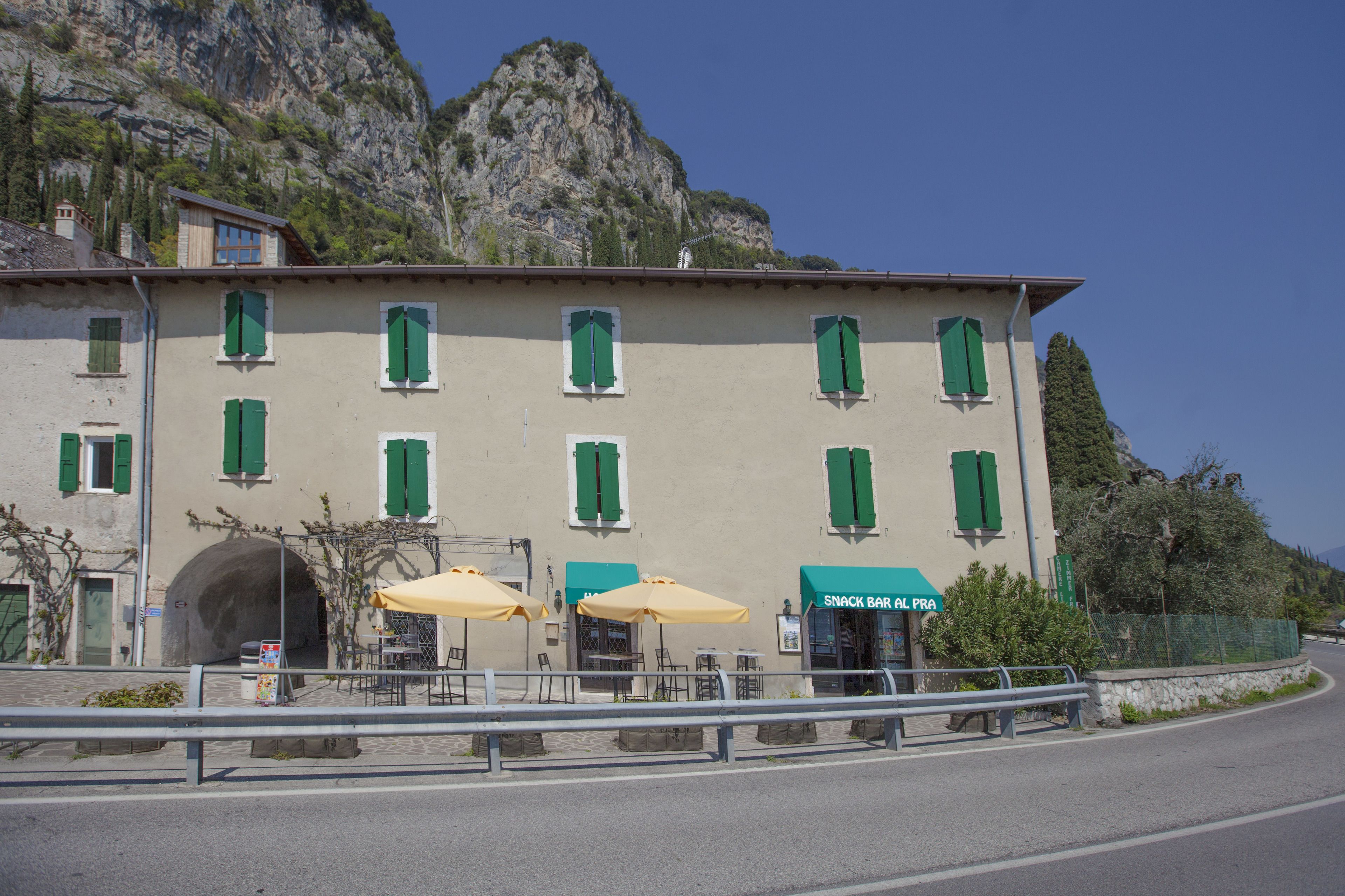 A building with multiple windows and a sign for a snack bar.