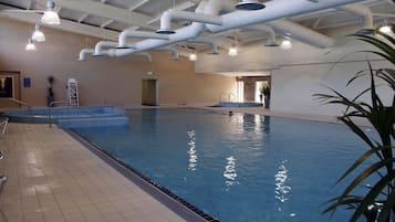 Swim laps in the spacious pool with a clear water surface and a tiled floor.