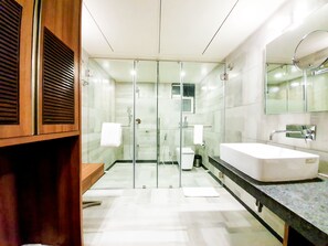 Enjoy a refreshing shower in the bathroom with a glass-enclosed shower area and handheld showerhead.