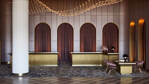 A reception area with a modern design, featuring a reception desk, two chairs, and a decorative ceiling light fixture. - Hotel Chadstone Melbourne MGallery Collection (Chadstone)