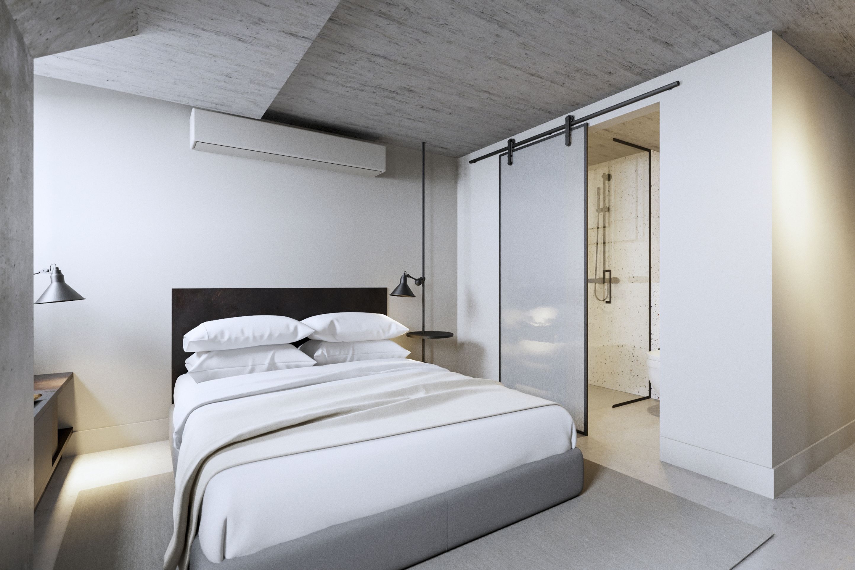 A modern bedroom with a bed, bedside table, and a sliding door leading to a bathroom.