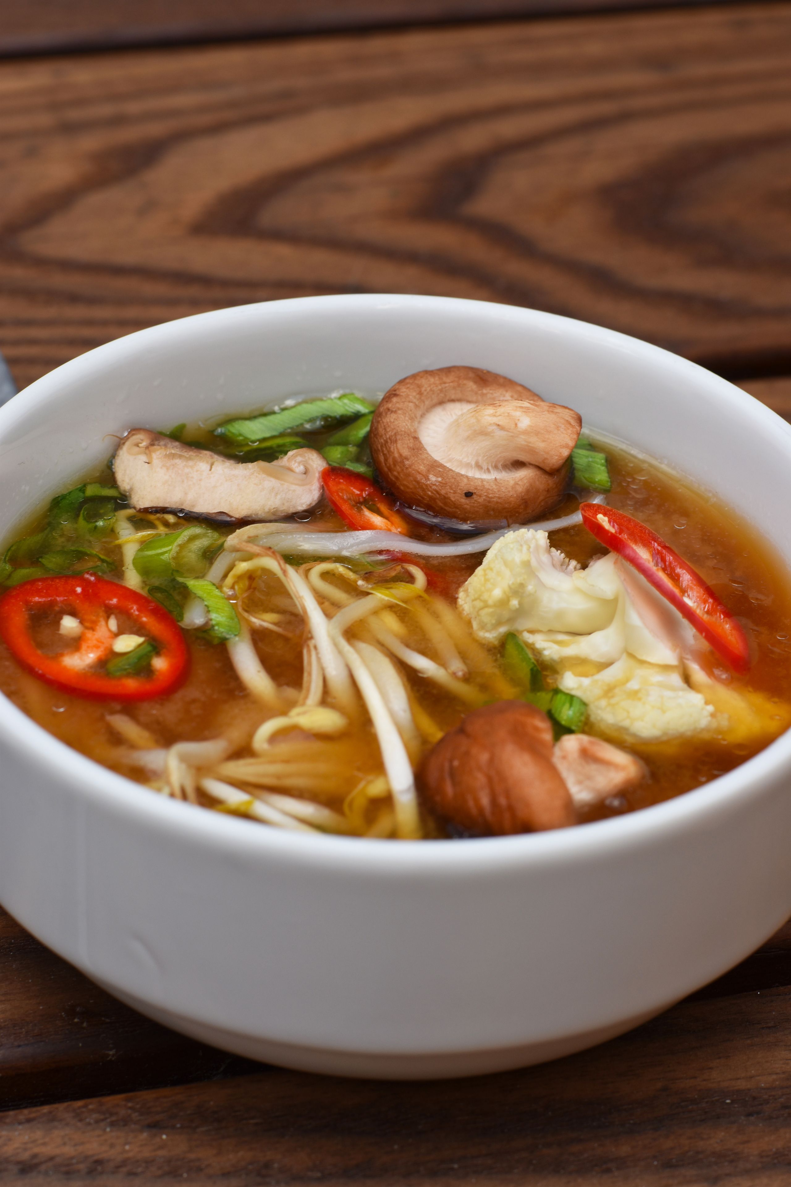 A bowl of soup with noodles, vegetables, and meat.