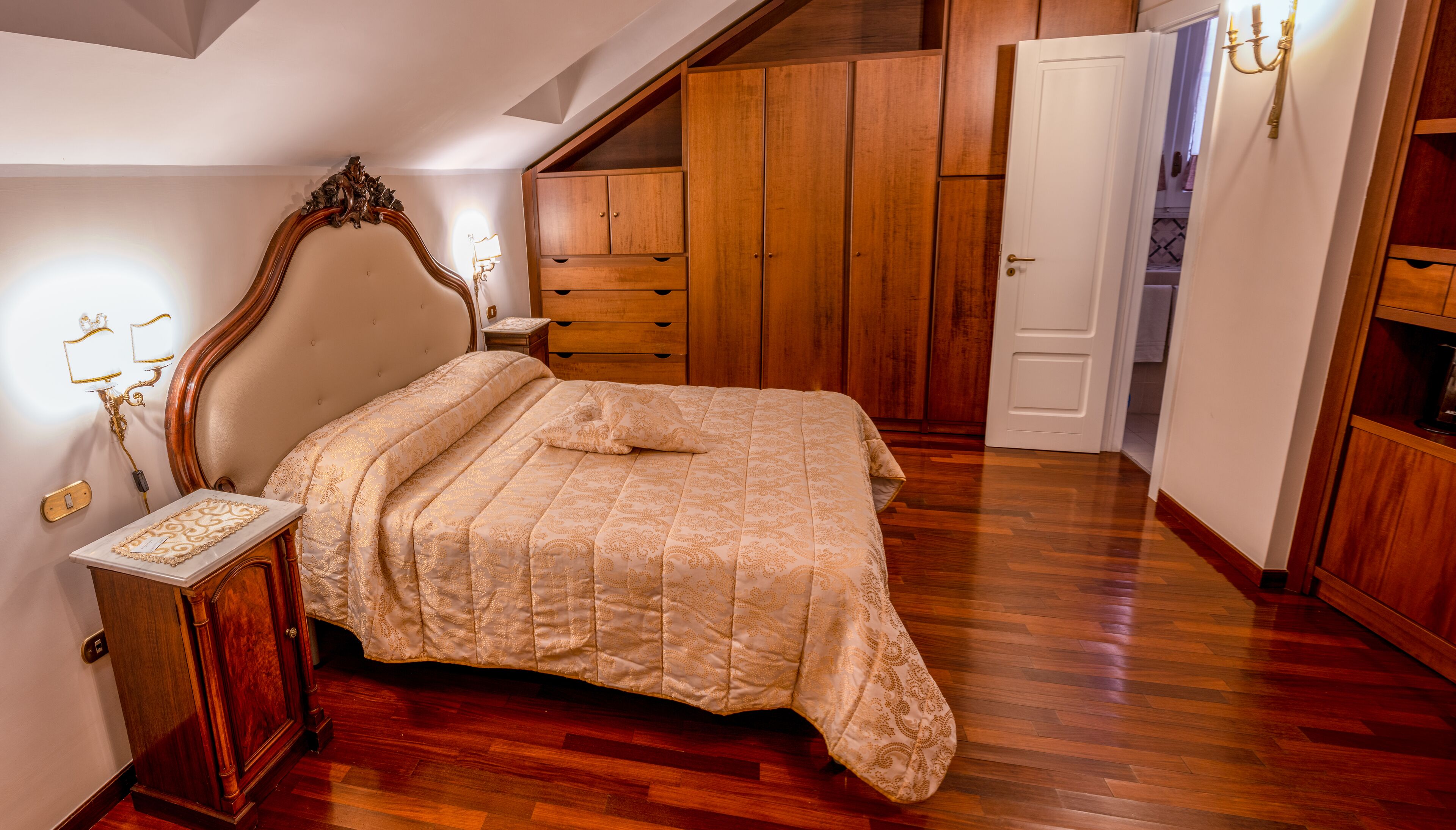 Une chambre à coucher avec un lit en bois, une table de chevet, une commode et une armoire.