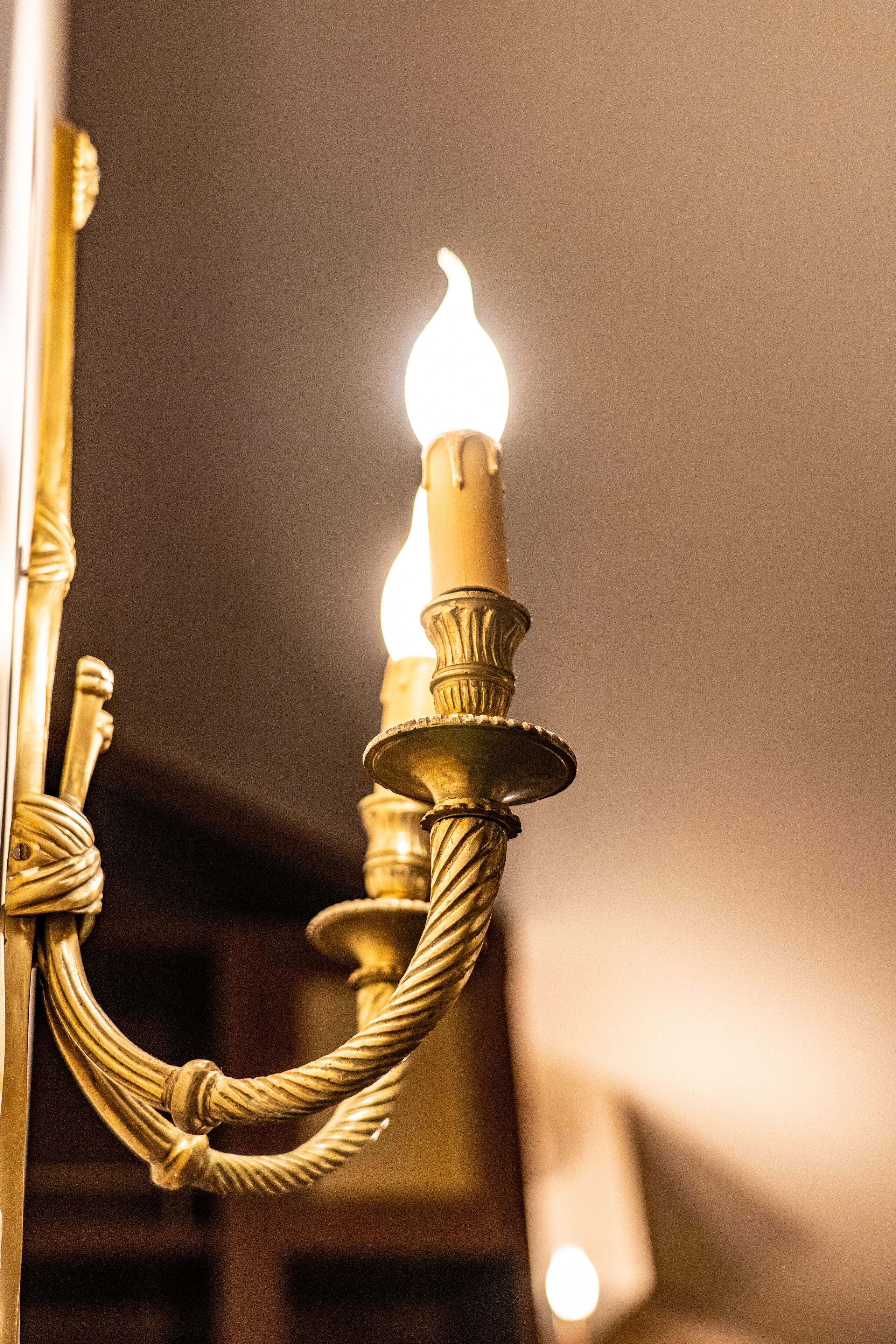 A close-up of a candle holder with a lit candle.