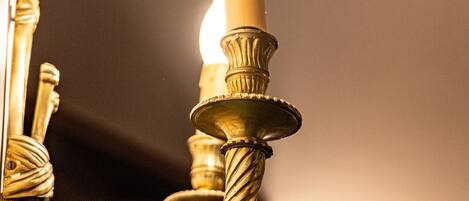 A close-up of a candle holder with a lit candle.
