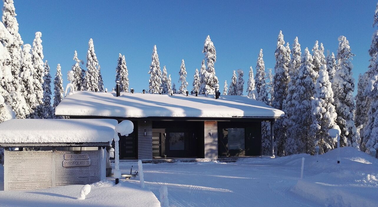 A modern building with a snow-covered roof and a sign reading "BIRKENTROL" and "CYPYRLUKI 3".