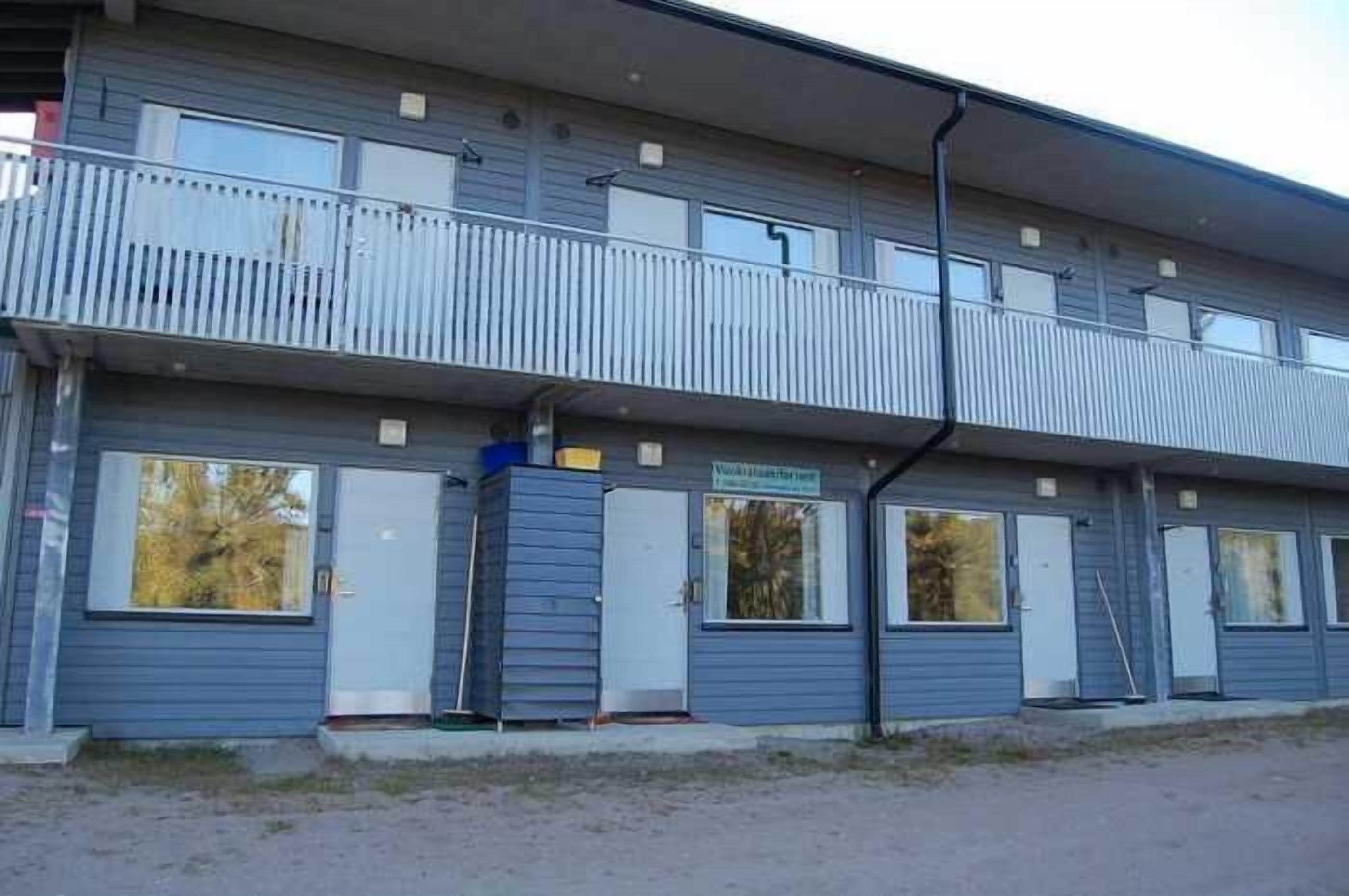 A two-story building with a balcony on the upper floor.