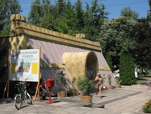 A building with a reception area, a map, and a bicycle.