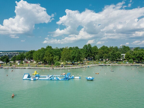 A waterfront park with water slides and a swimming area.