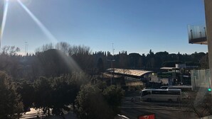A clear view of a bus station with a bus, trees, and a building in the background.
