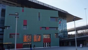 A modern building with a flat roof and large windows.