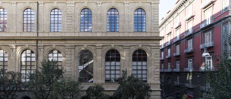 A historic building with arched windows and a central staircase.