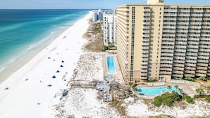 A beachfront hotel with a pool, beach, and ocean view. - Pelican Beach 1811 1 Bedroom Condo by RedAwning (Destin)