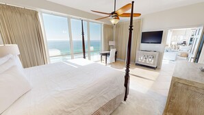 A spacious bedroom with a large bed, a ceiling fan, and a view of the ocean. - Oceania 906 3 Bedroom Condo by RedAwning (Destin)