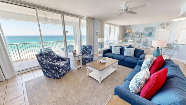 A spacious living room with a large balcony overlooking the ocean, furnished with a sofa, armchairs, and a coffee table. - Oceania 607 3 Bedroom Condo by RedAwning (Destin)