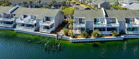 A coastal residential area with houses featuring balconies and waterfront views.
