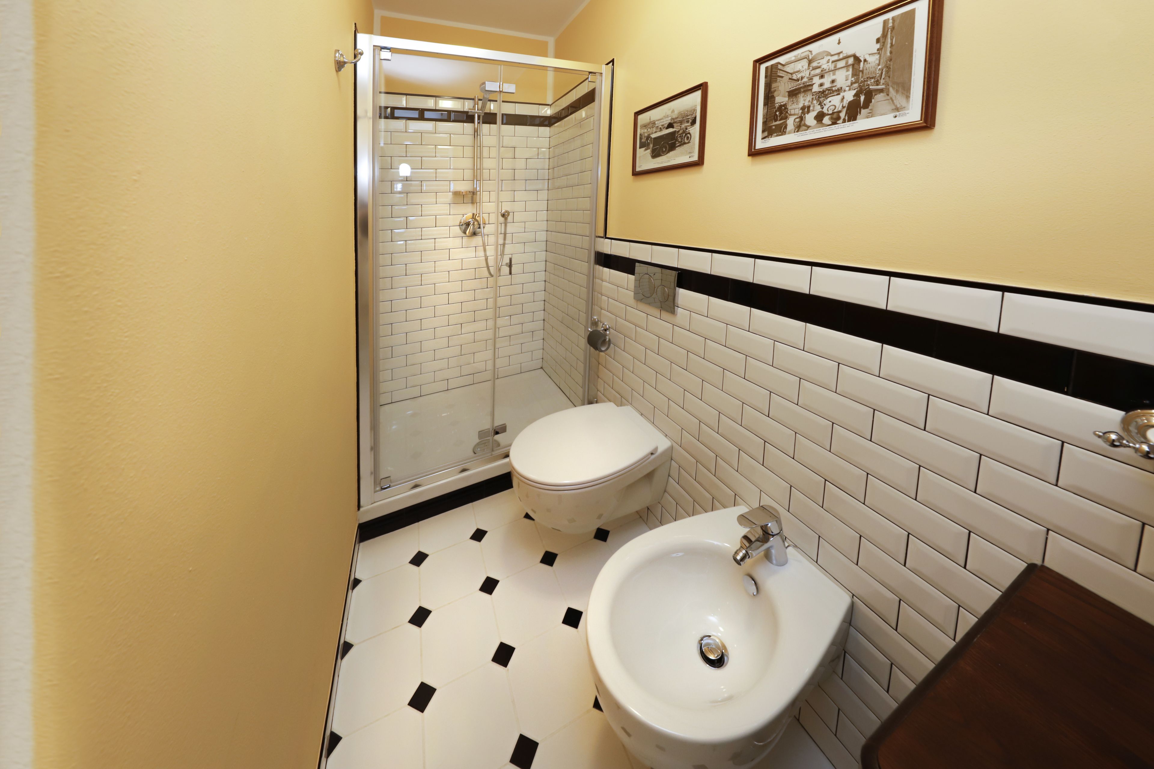 A bathroom with a shower, toilet, and sink.