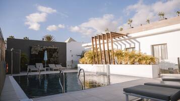 Outdoor pool, open 10:00 AM to 7:00 PM, pool loungers