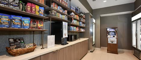 A self-service breakfast area with shelves stocked with snacks, cereals, and beverages.