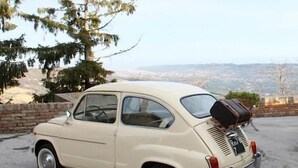 A vintage car parked on a driveway with a scenic view in the background. - Hotel Ristorante Due Platani (Cornedo Vicentino)