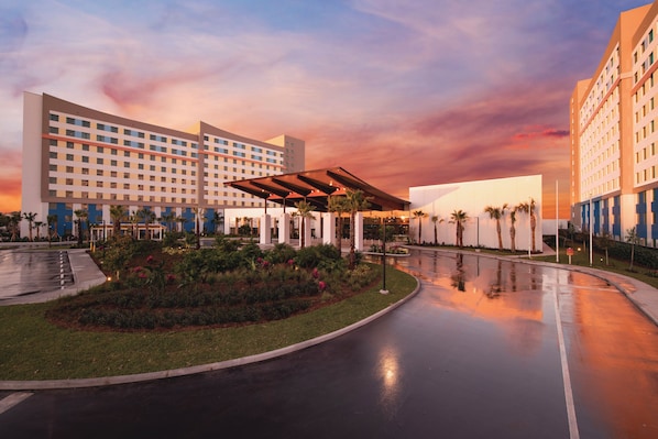 A hotel with a modern design, featuring a large building with multiple floors and a covered outdoor area with seating. - Universal's Endless Summer Resort - Dockside Inn and Suites (Orlando)