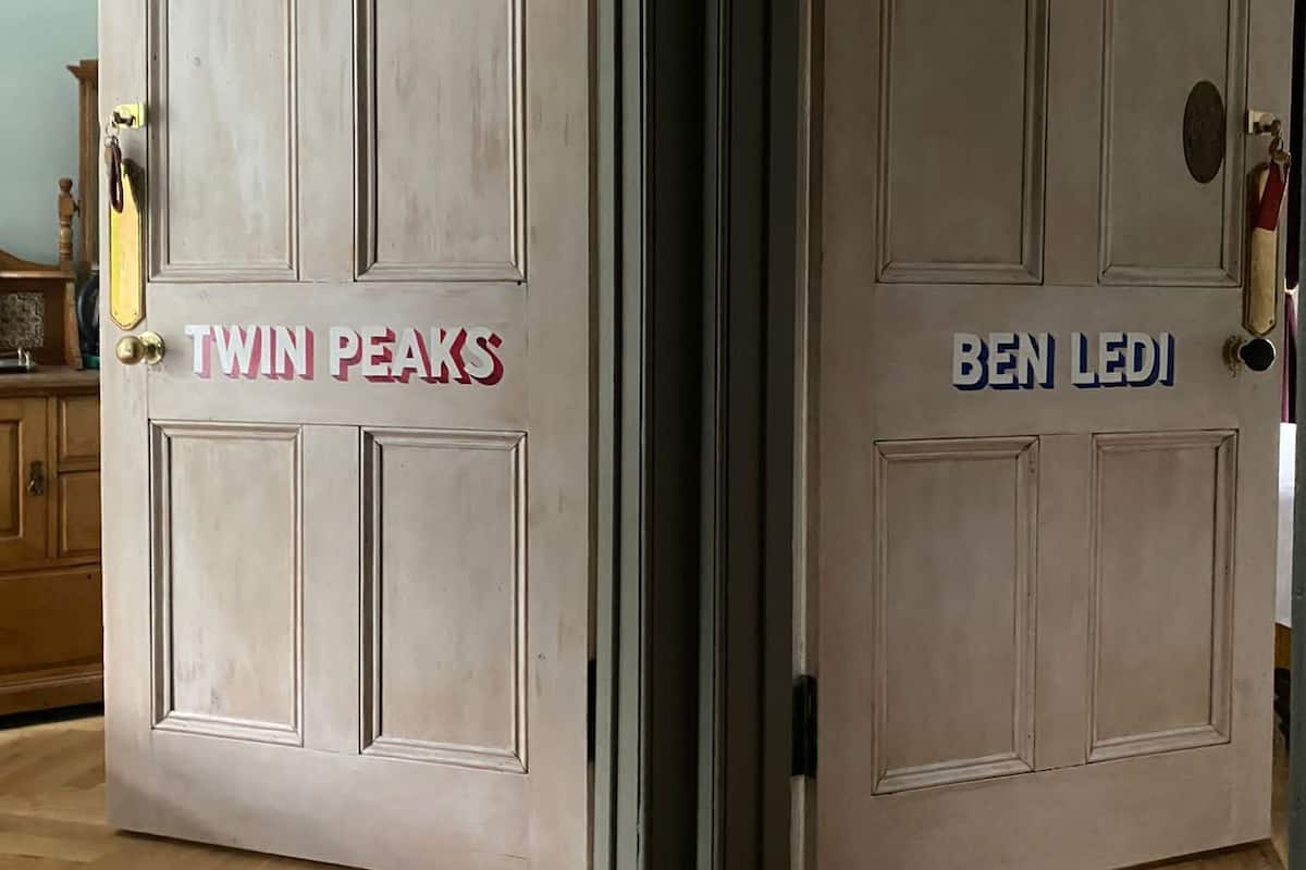 A set of double doors with the names "TWIN PEAKS" and "BEN LEDI" on them.