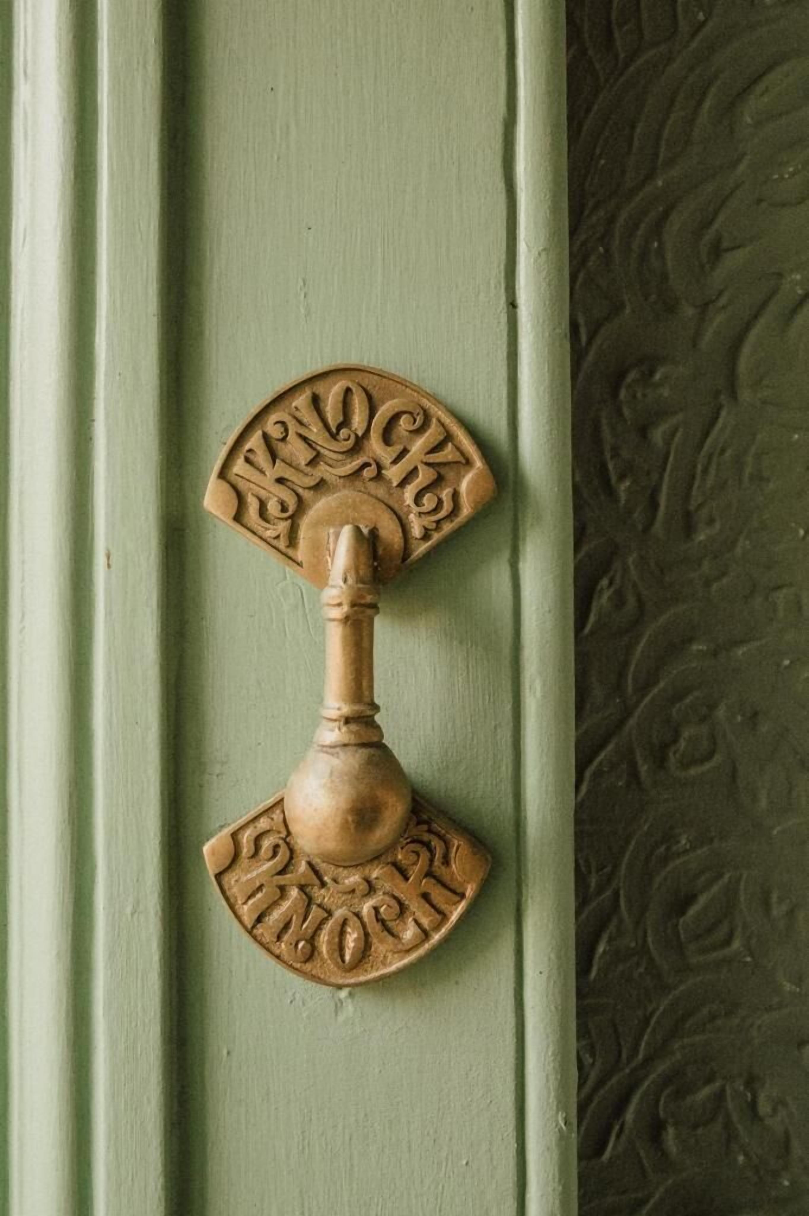 Una manilla de porta amb un disseny decoratiu i la paraula 'LOCKS' gravada.