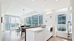 Executive Condo, 2 Bedrooms, Hot Tub, City View | Private kitchen | Coffee/tea maker, full-size fridge, microwave, oven - Suite Digs Waterfront Court (Calgary)