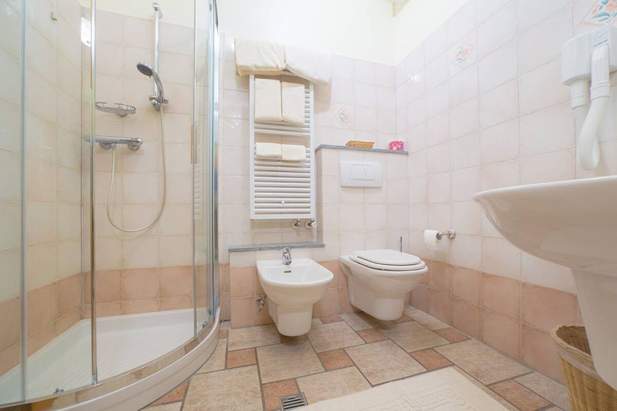 shower, rainfall showerhead, hair dryer, slippers