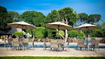 Seasonal outdoor pool, open 9:00 AM to 9:00 PM, pool umbrellas