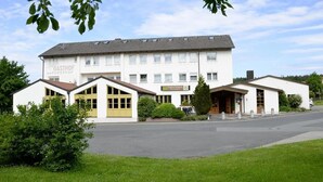 Ein Gebäude mit einem Schild, auf dem 'GASTHOF AN FÖRSTHOF' steht, und einem kleineren Schild für 'Gästehaus An der Furt'.