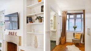 A living room with a fireplace, a TV mounted on the wall, and a bookshelf with various decorative items. - Cavendish - By Sojourn (London)