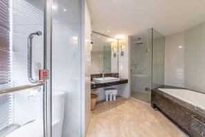 A modern bathroom with a glass shower enclosure, a large mirror, a marble sink, and a bathtub. - Jialuan International Hotel (Taizhou)