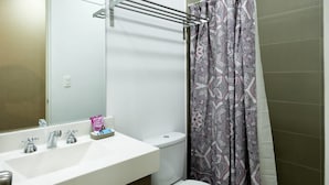 A bathroom with a white sink, a mirror, a towel rack, a toilet, and a shower curtain. - UR Place Rentals - 3Bdrm Av Brasil Lima (Lima)
