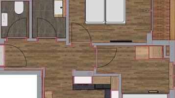 A hotel room layout with a bathroom, kitchenette, and seating area.