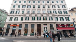 A multi-story building with a large storefront on the ground floor. - B&B Dream Center (Trieste)
