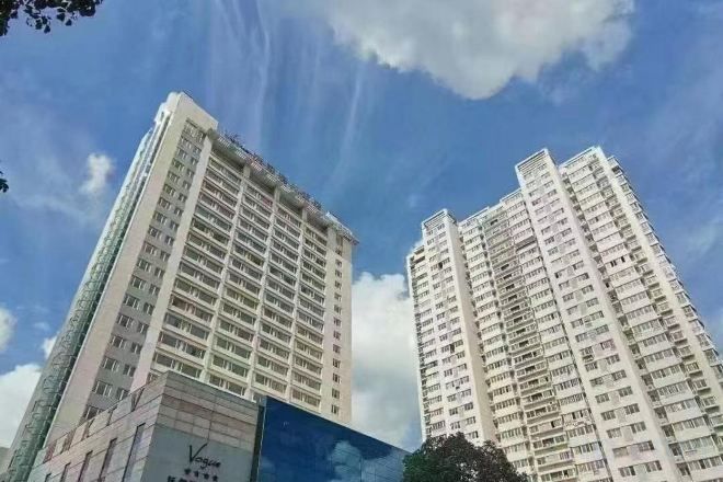 Two high-rise buildings with a clear sky.