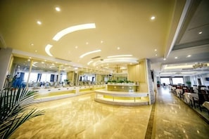 A spacious lobby with a central seating area, a high ceiling with recessed lighting, and a reflective floor. - Sizhou Hotel (Xuyi)