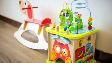 A colorful children's toy with various shapes and a small owl figure.
