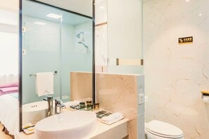 A modern bathroom with a glass shower enclosure, a white sink, and a toilet. - Yeshi International Hotel (Shuyang)