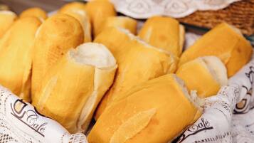 A basket of freshly baked croissants and a sign with the text "Doces Deliciosos".