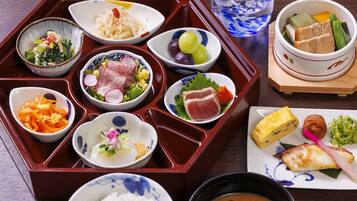 A traditional Japanese bento box with various food items including rice, vegetables, fish, and tofu.