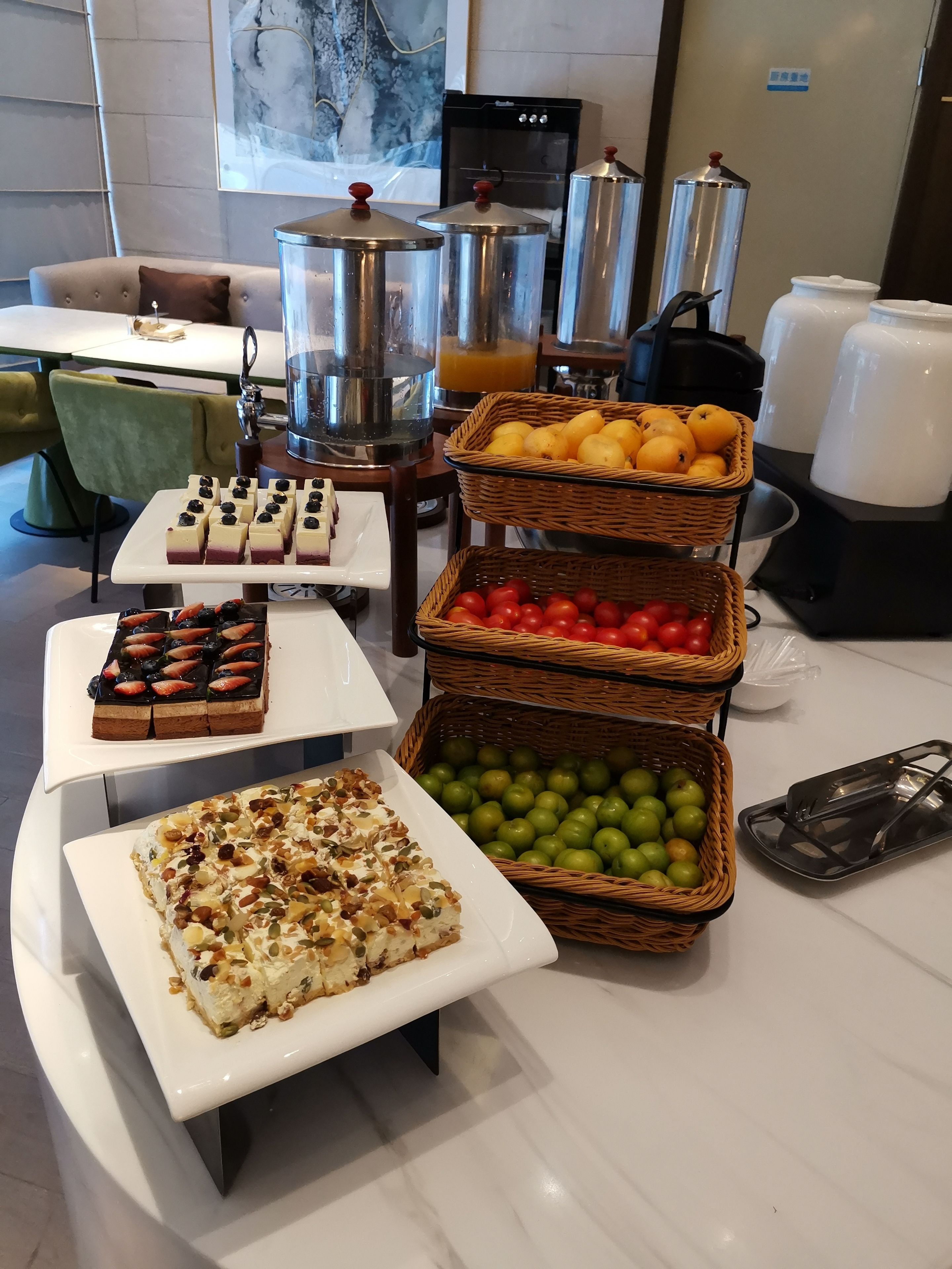 A buffet setup with various food items and beverages.