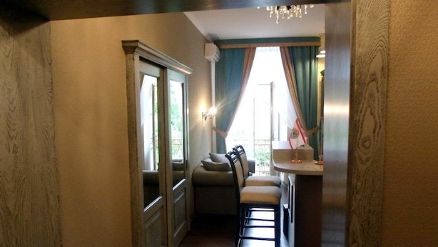 A hallway leading to a seating area with a view of the outdoors. - Mini Hotel D'Rami (Almaty)