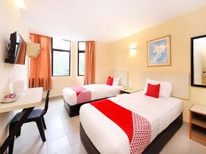A hotel room with two beds, a desk, a chair, a TV, and a window with curtains. - Super OYO 635 Seven Days Hotel (Raub)