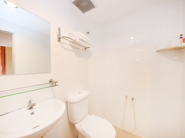 A bathroom with a sink, toilet, and shower.